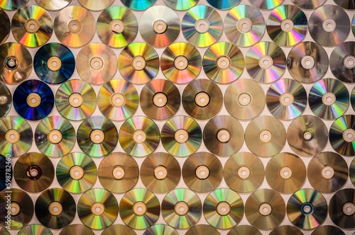 Conceptual old school music background. Background on the wall with old damaged and dirty discs cd.