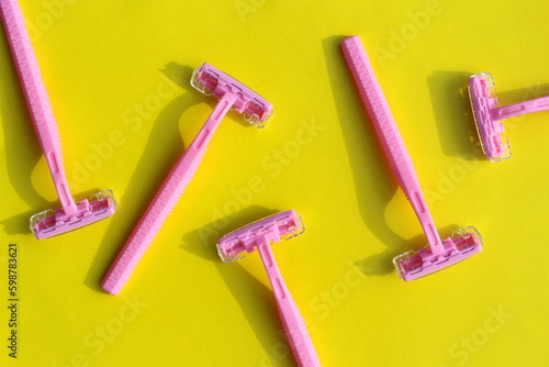 Several razors lie on a yellow background. photo