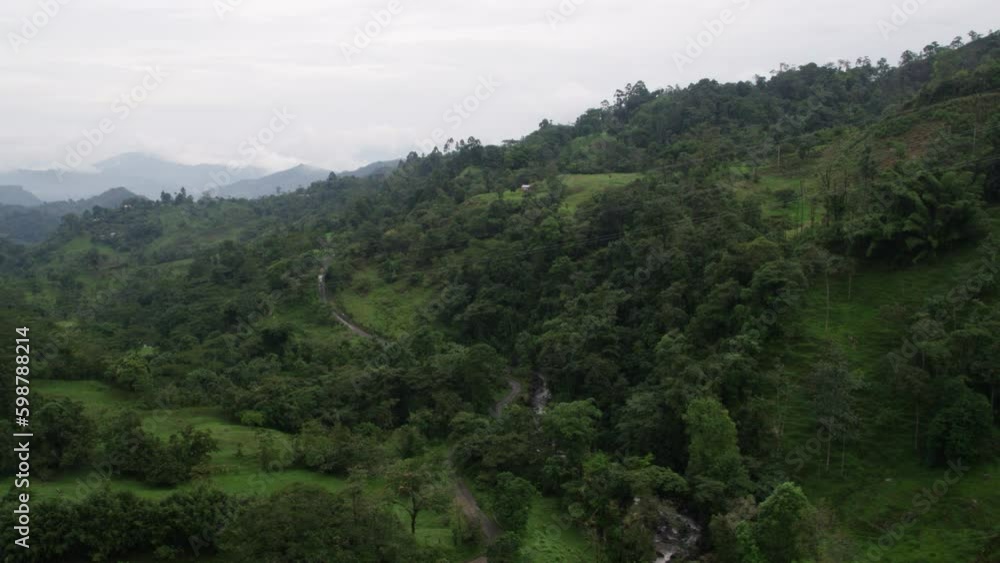flight aerial shot along green jungle forest mountains, rainforest vegetation landscape, rural drone shot with mountainview. flight aerial shot along green jungle forest mountains, rainforest vegetation landscape, rural drone shot with mountainview.