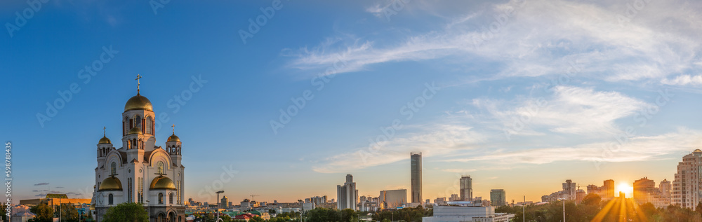 Panorama of spring or summer Yekaterinburg and Temple on Blood in orange sunset light. Yekaterinburg, Russia