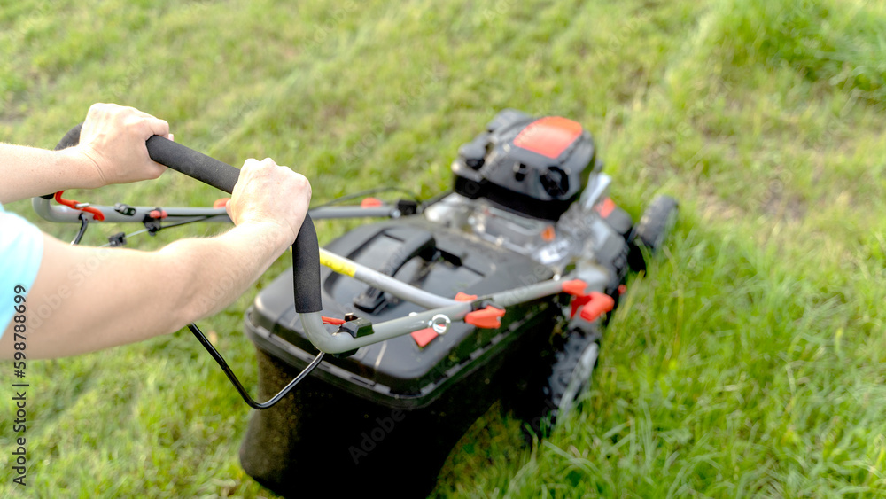 a girl with a lawn mower mows a beautiful lawn a girl with a lawn mower mows a beautiful lawn
