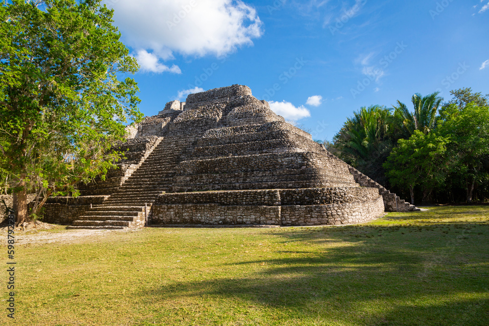 Mayan Ruins in Central American. Chacchobean Mayan ruin site in Mexico view of a large pyramid or temple in an open plaza Mayan Ruins in Central American. Chacchobean Mayan ruin site in Mexico view of a large pyramid or temple in an open plaza