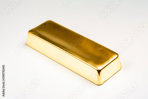 An unadorned gold bar sits on a plain white backdrop in studio lighting, free from any text or markings. generative AI.