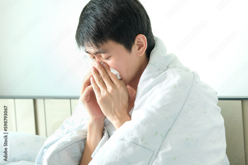 man sick with flu Use a paper napkin and have a runny nose. and he was covered with a warm cloth, health concept man sick with flu Use a paper napkin and have a runny nose. and he was covered with a warm cloth, health concept
