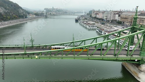 Aerial view of Budapest Szabadsag hid (Liberty Bridge or Freedom Bridge), connects Buda and Pest across the River Danube. A tram circulates within historic city along iconic bridge