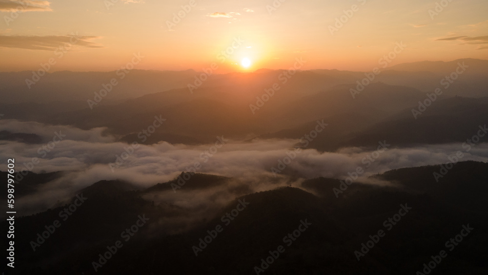 Sunrise landscape under the beautiful cloud valley as the mist moves around the hill Sunrise landscape under the beautiful cloud valley as the mist moves around the hill
