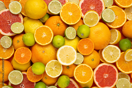 Concept for fresh, fruity and juicy fruit. Top view. Delicious fruit background made of many different colorful fresh cut, halved and whole citrus fruits