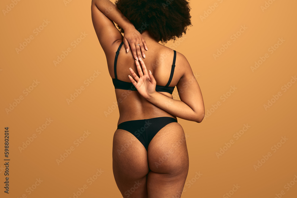 Crop plump black woman stretching arms behind back Generative AI - obrazy, fototapety, plakaty 