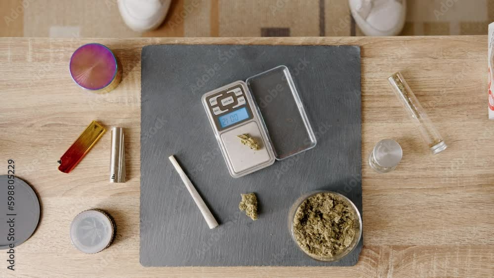 Daily morning routine of a dealer while weighing marijuana to send to customers Daily morning routine of a dealer while weighing marijuana to send to customers