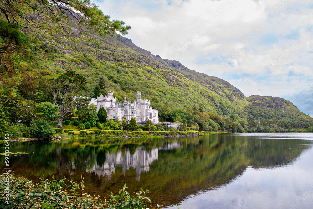 Kylemore Abbey with water reflections in Connemara, County Galway, Ireland, Europe. Benedictine monastery founded 1920 on the grounds of Kylemore Castle. Mainistir na Coille Moire