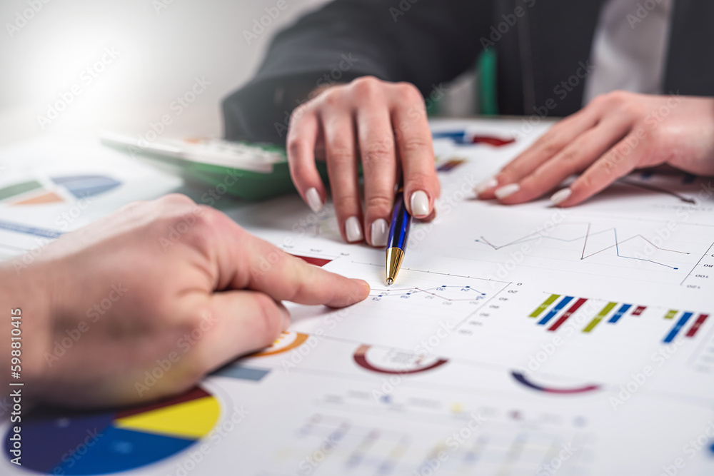 Manager working with finance charts graph and doing annual analytic research document at office Manager working with finance charts graph and doing annual analytic research document at office