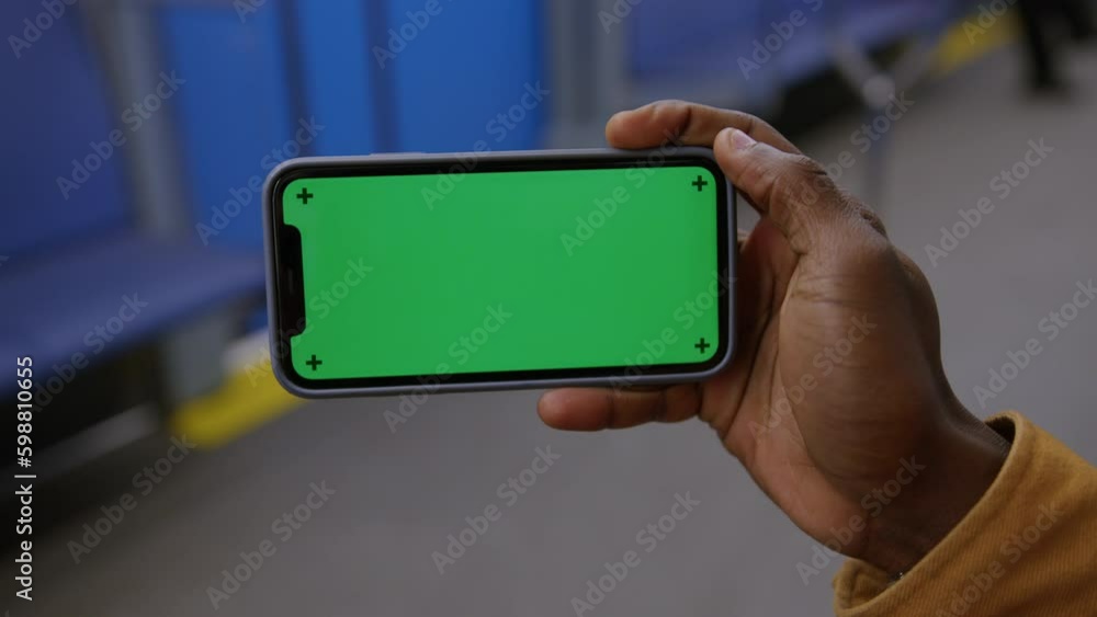 Hand of an African-American man holding a smartphone with a chromakey Generative AI Hand of an African-American man holding a smartphone with a chromakey Generative AI