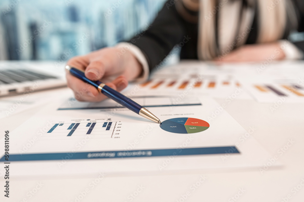 Beautiful caucasian business woman wear suit work with financial graph nad chart Beautiful caucasian business woman wear suit work with financial graph nad chart