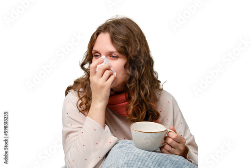 Foto A sick woman blows her nose into a napkin with a cup in her hand, a runny nose, isolated on a white background