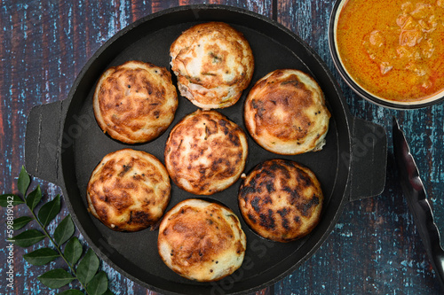 Indian breakfast kuzhi paniyaram in a frying pan.