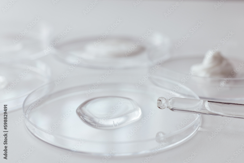 Pipette with Sample of Gels Cosmetic Product in Petri Dish on white background Pipette with Sample of Gels Cosmetic Product in Petri Dish on white background