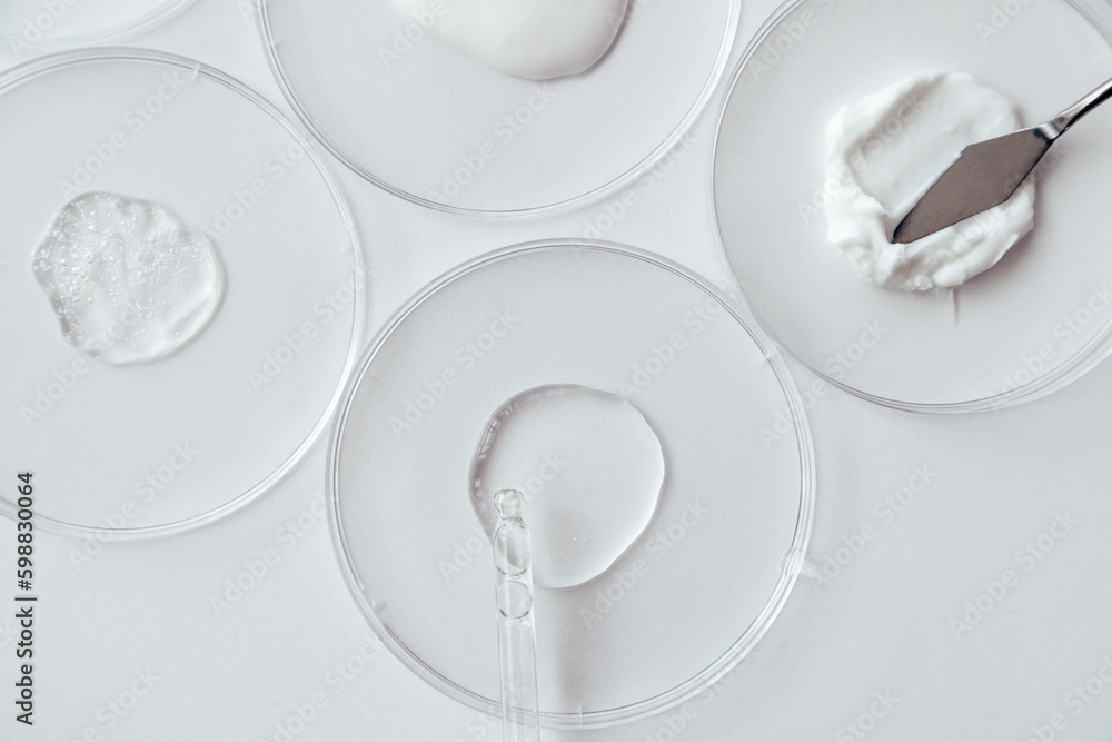Cosmetics Samples in Laboratory Glassware on white background, consistency test of gel and cream