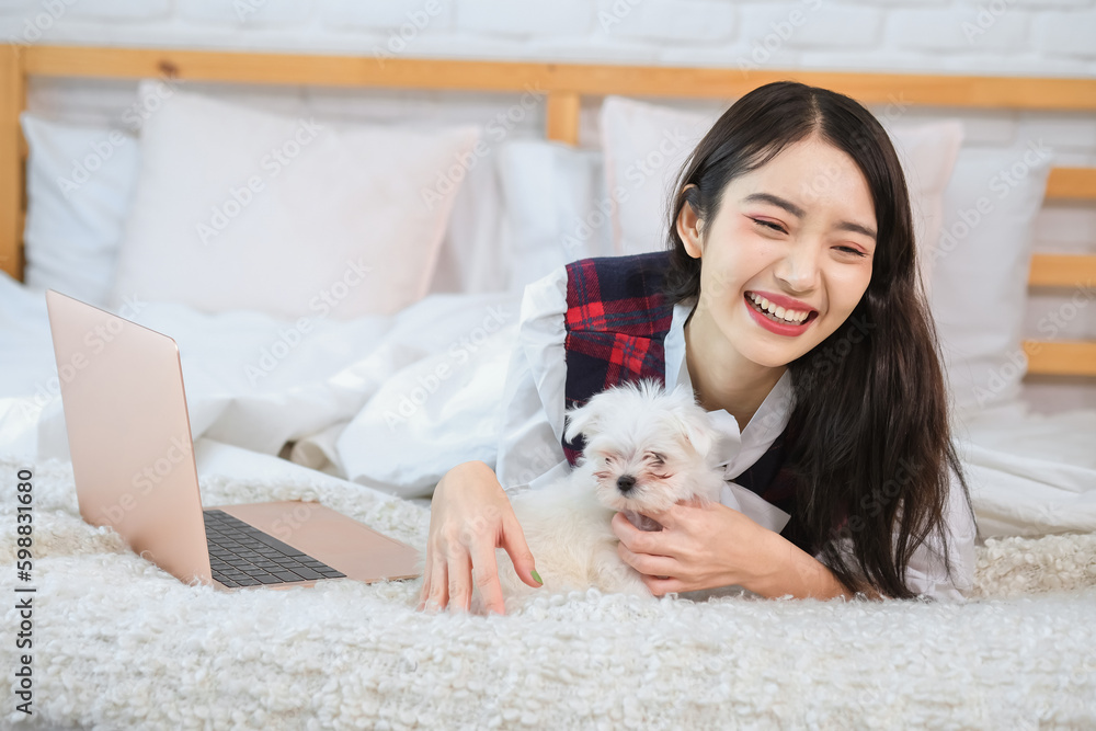 The dog's paw is resting on the owner's hands showing its trust and comfort with her touch. The dog's paw is resting on the owner's hands showing its trust and comfort with her touch.