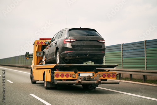 Photos Tow truck with broken car on country road