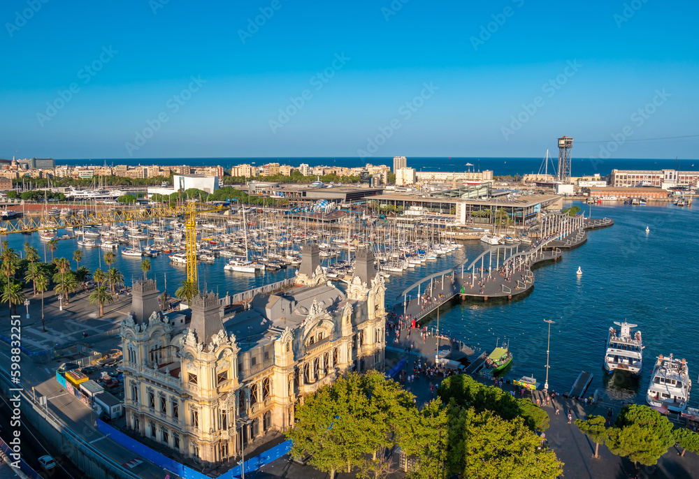 Panoramic aerial view of the port of Barcelona, Port Vell from the top of Columbus Monument at sunset