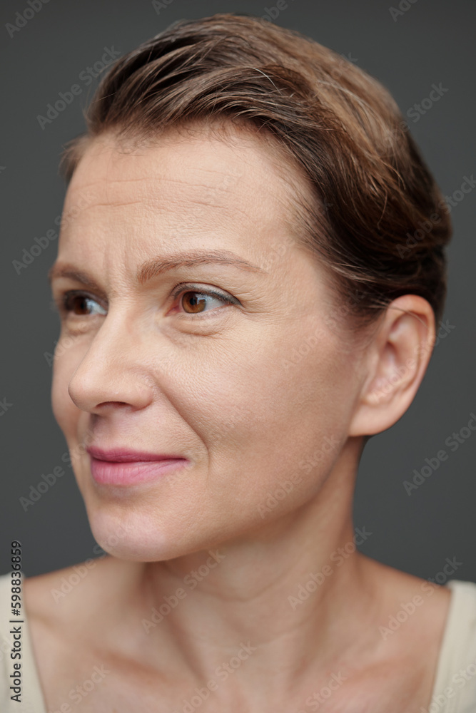 Face of smiling mature woman looking away