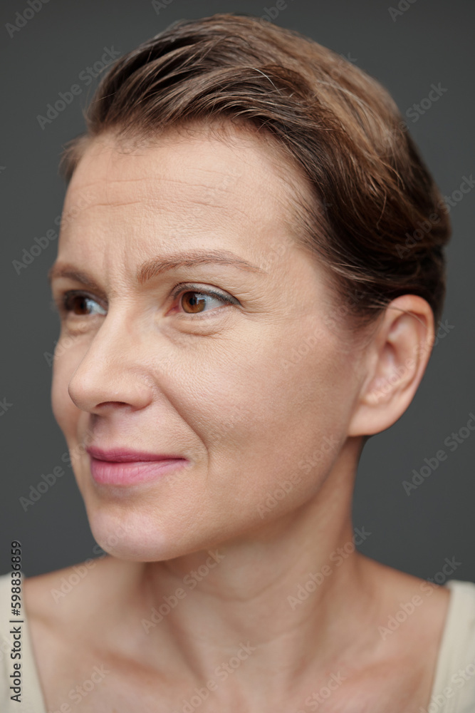 Face of smiling mature woman looking away Face of smiling mature woman looking away