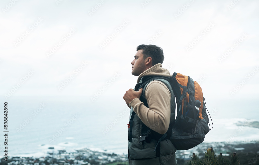 Fresh air is mans best medicine. a young man hiking through the mountains.