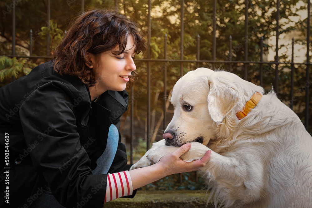 Cute funny girl portrait with her golden dog
