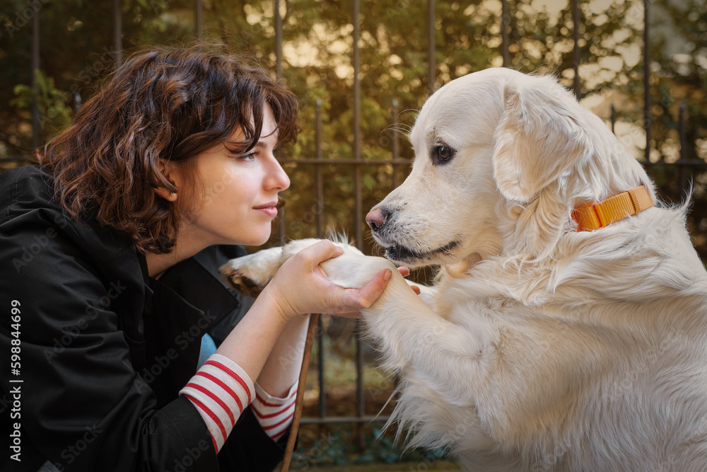 Cute funny girl portrait with her golden dog