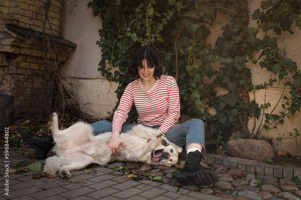 Cute funny girl portrait with her golden dog