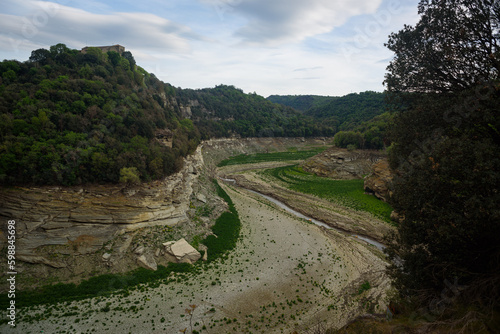 Sau, Spain - 28 April 2023: The Ter river is seen before the Sau reservoir as the drought caused by climate change causes water shortages in Spain and Europe.