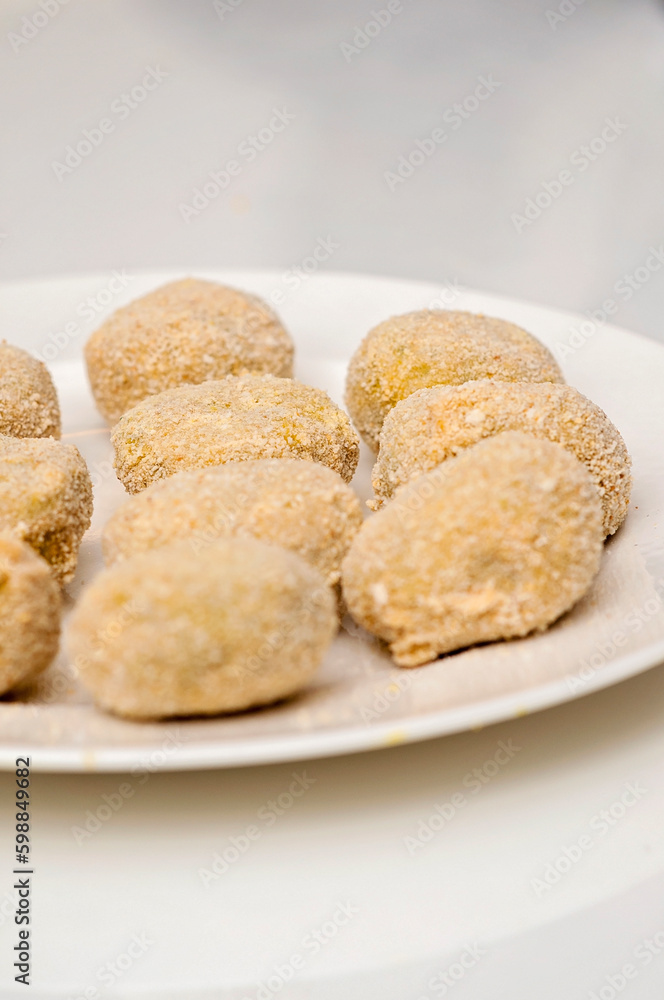 Handmade falafel balls ready to cook. Plate prepared with raw falafel is half finished fod. Meatless vegetarian food. Handmade falafel balls ready to cook. Plate prepared with raw falafel is half finished fod. Meatless vegetarian food.