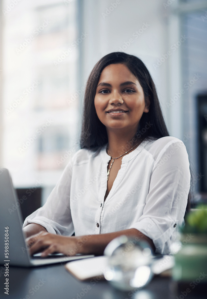 Success lies in the path of those who show dedication. Portrait of a young businesswoman working on a laptop in an office. Success lies in the path of those who show dedication. Portrait of a young businesswoman working on a laptop in an office.