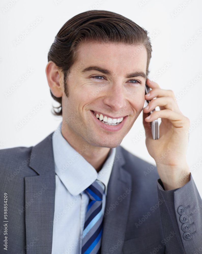 Networking is his speciality. A smiling young businessman talking on his smartphone. Networking is his speciality. A smiling young businessman talking on his smartphone.