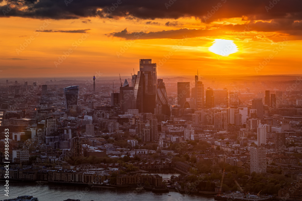 Elevated, panoramic view of the skyine at the City of London, England, during a golden sunset