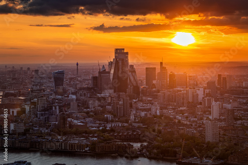 Elevated, panoramic view of the skyine at the City of London, England, during a golden sunset © moofushi