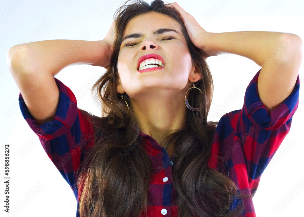 Im losing it. Studio shot of a young woman looking stressed out against a white background. Im losing it. Studio shot of a young woman looking stressed out against a white background.