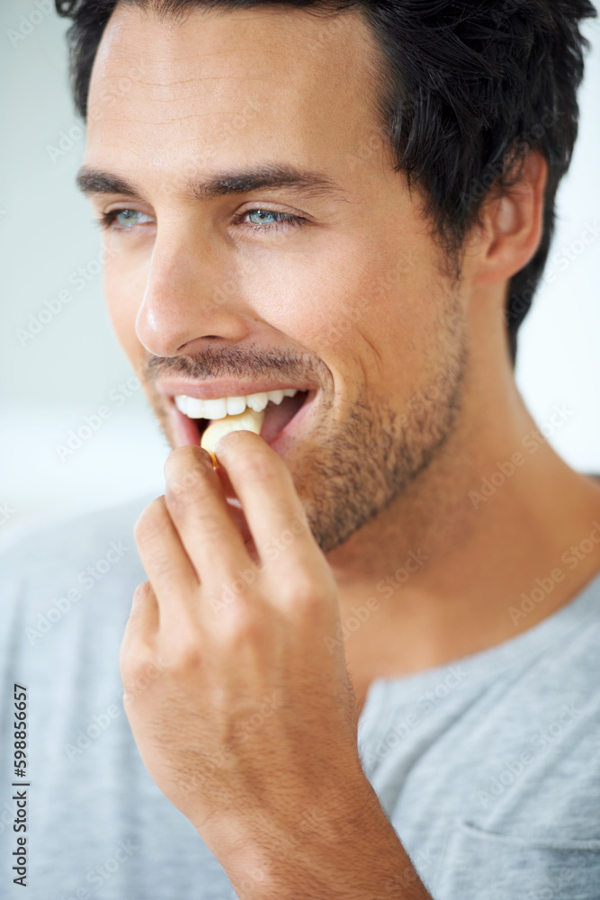 Tasty treats. Profile of a smiling gorgeous young man eating a slice of apple. Tasty treats. Profile of a smiling gorgeous young man eating a slice of apple.