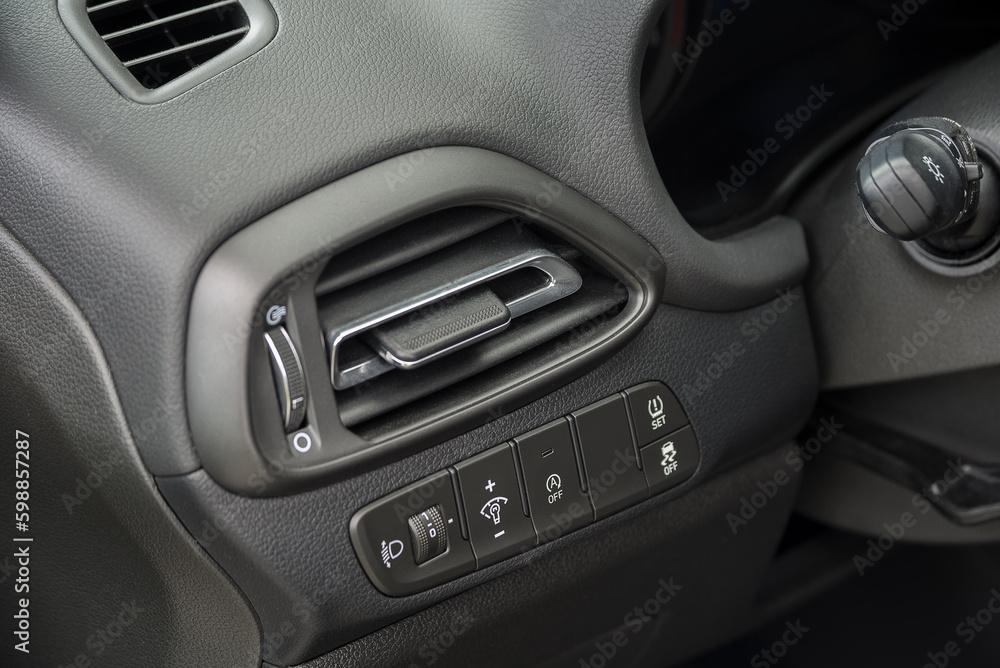 Air vent grill in a car. Air conditioner grid and control panel buttons. Air vent grill in a car. Air conditioner grid and control panel buttons.