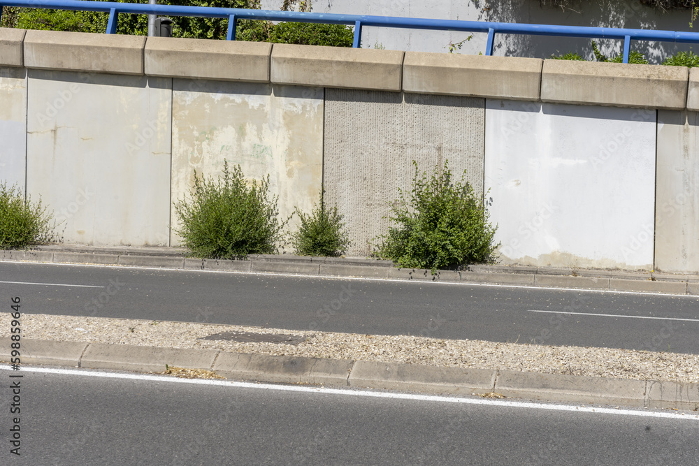 Highway Ramp Wall An urban highway with a median dividing both directions and a ramp with ...
