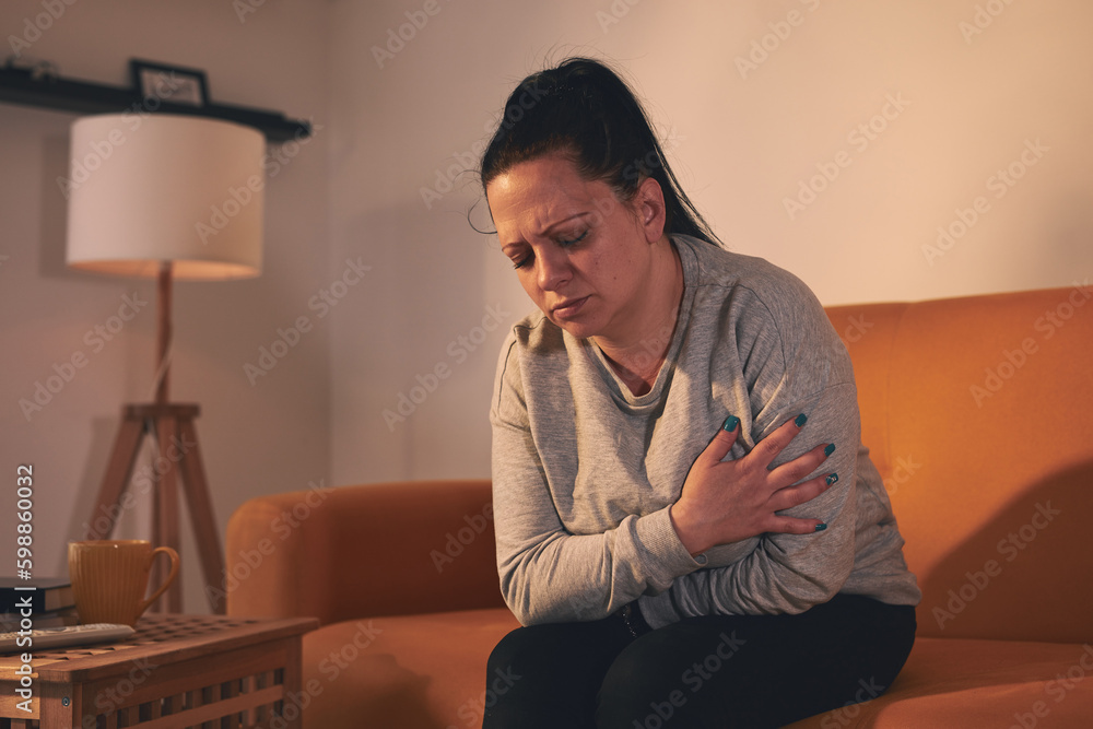 Woman with strong stomach ache and digestive issues at home. Woman with strong stomach ache and digestive issues at home.