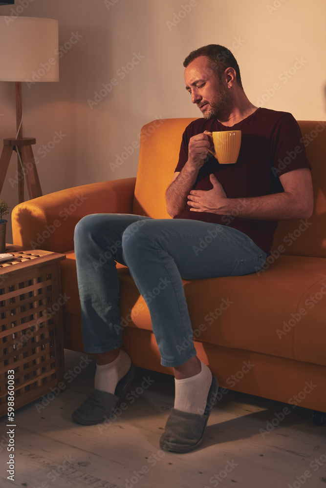 Man at home suffering from stomach pain. Man at home suffering from stomach pain.