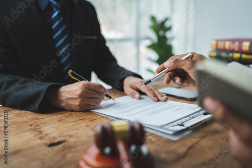 A lawyer or legal advisor explains the terms of the contract before signing a legal contract signing agreement. the concept of righteousness and justice.