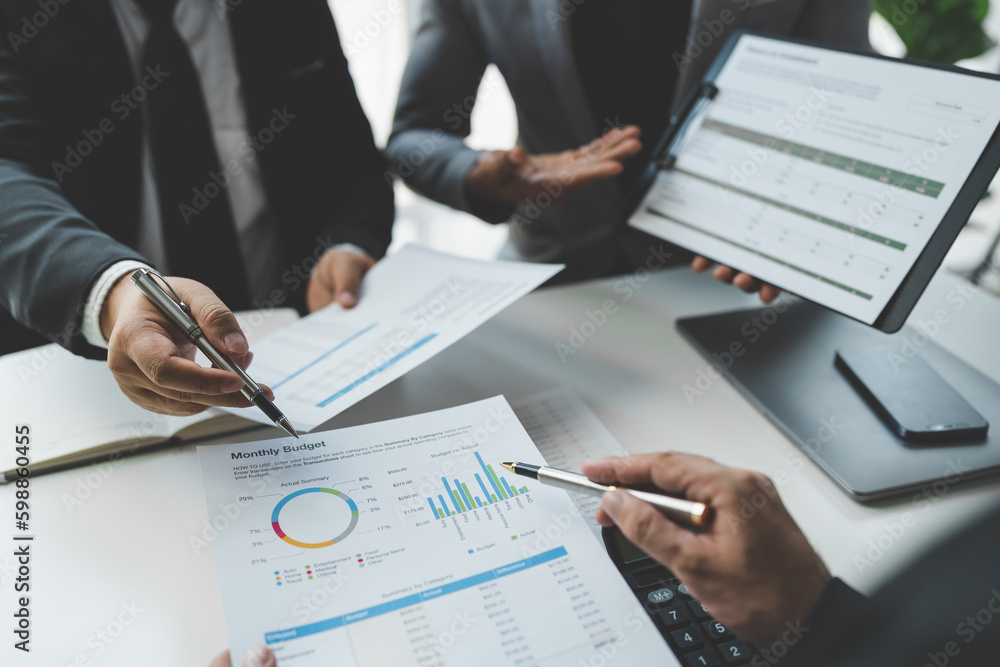 Businessman discussing with colleague plan analyzing financial data charts and graphs. sales strategy Calculate a numerical balance sheet from papers at successful meetings and teamwork. Businessman discussing with colleague plan analyzing financial data charts and graphs. sales strategy Calculate a numerical balance sheet from papers at successful meetings and teamwork.