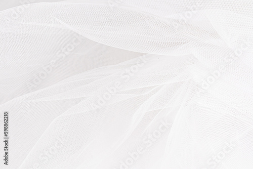 Delicate texture of the background. Elegant soft tulle fabric. Bridal wedding foil close-up for design, plase for text. photo