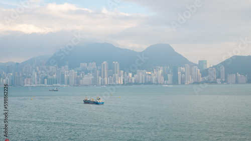 View of Hong Kong Victoria Harbour cityscape with many skyscraper buildings from sea.