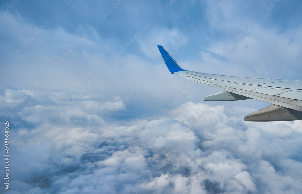 View of the beautiful sky and clouds from the window of the airplane. Sunset sky from the window of the airplane. View of the beautiful sky and clouds from the window of the airplane. Sunset sky from the window of the airplane.