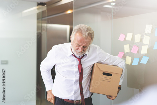 Senior employee carrying stuff box and ready to retired from company. photo