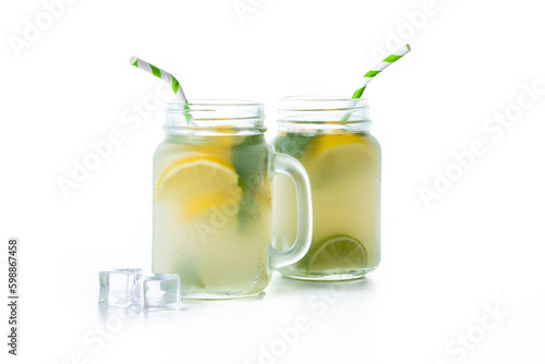 Lemonade drink in a jar glass and ingredients isolated on white background