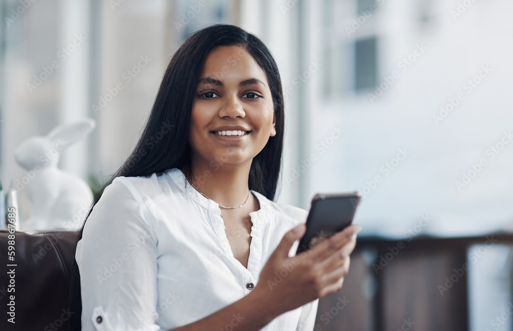 My connections are always close by. Portrait of a young businesswoman using a cellphone in an office. My connections are always close by. Portrait of a young businesswoman using a cellphone in an office.